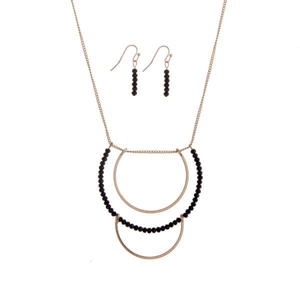 Wholesale gold necklace set displaying layered half rings black bead accents