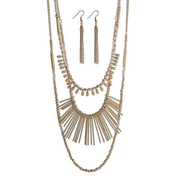 Wholesale gold layering necklace set displaying white gold beads metal fringe