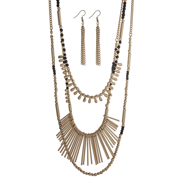 Wholesale gold layering necklace set displaying black gold beads metal fringe