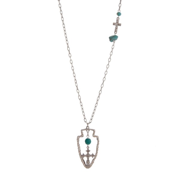 Wholesale burnished silver necklace displaying hammered cross station turquoise