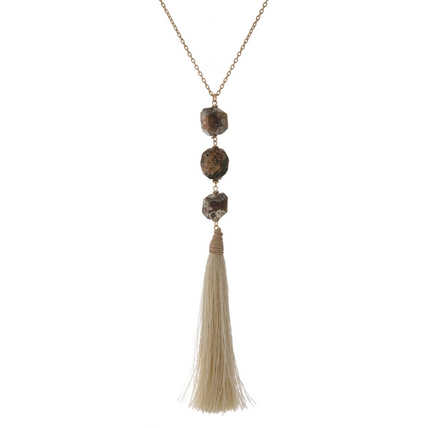 Wholesale gold necklace displaying three brown natural stone beads ivory fabric